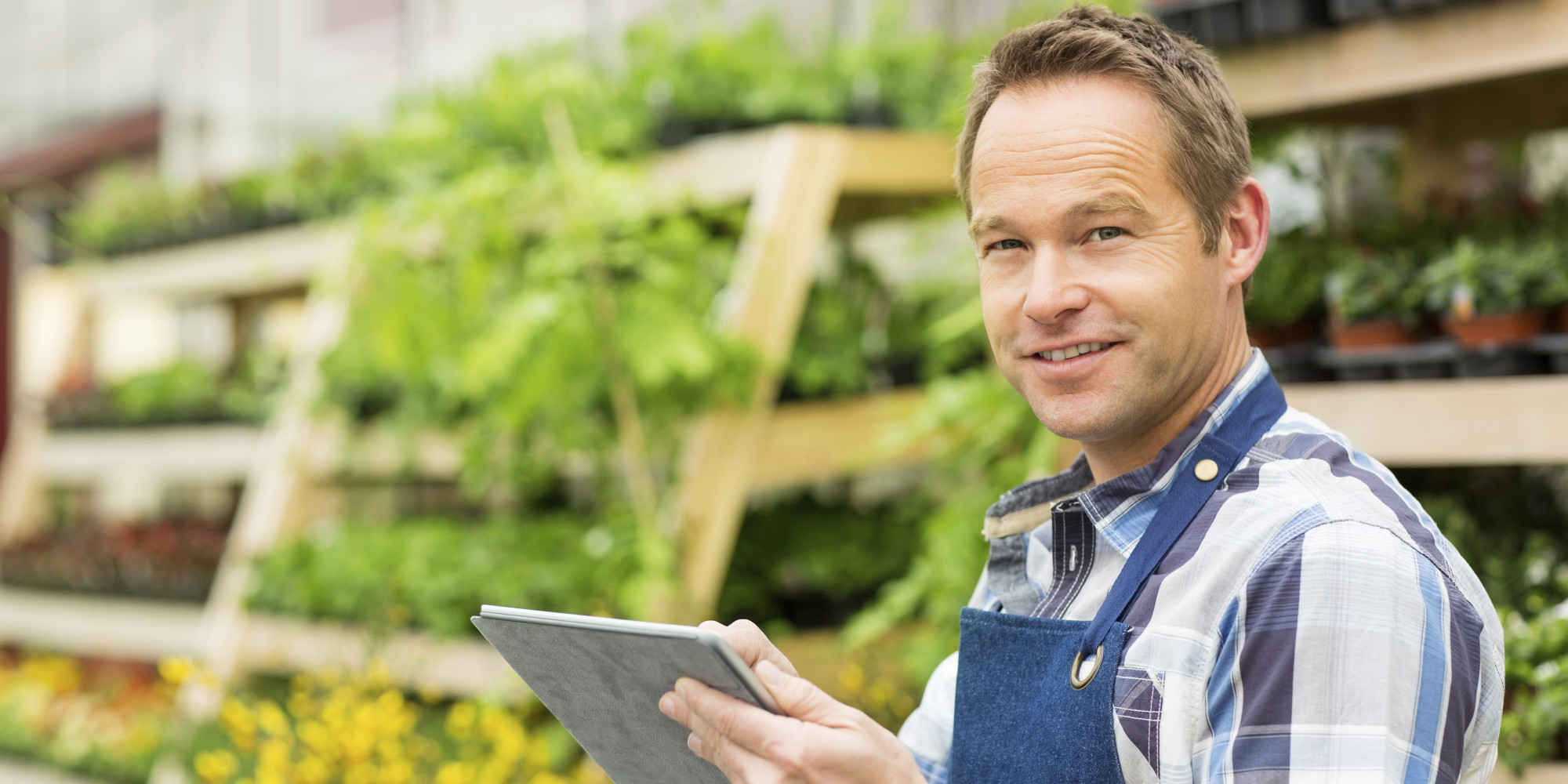 Male Garden Worker Using Digital Tablet